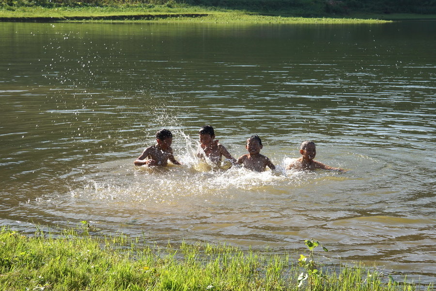村童戏水摄影图片